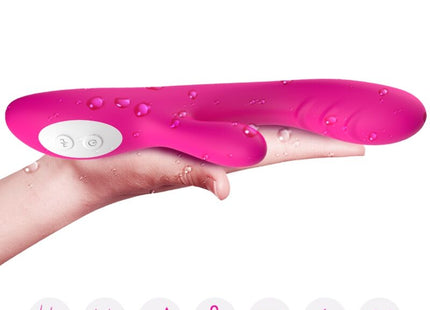 Fuchsienfarbener armony spark vibrator aus silikon mit weißem bedienfeld und wärmeeffekt mit wassertropfen