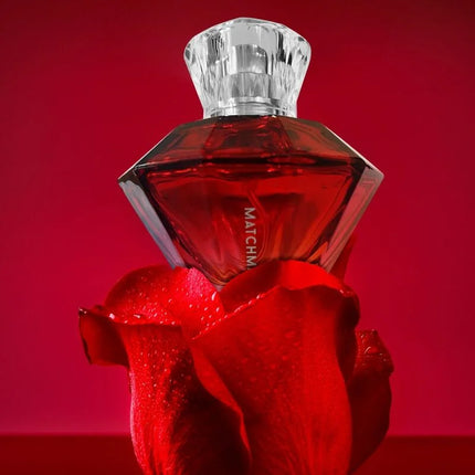 A red diamond-shaped pheromone perfume bottle auge der liebe matchmaker with faceted crystal stopper and match label