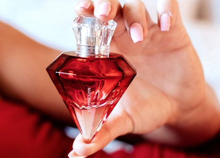 A vibrant red diamond-shaped pheromone parfum bottle auge der liebe with clear crystal stopper 30 ml