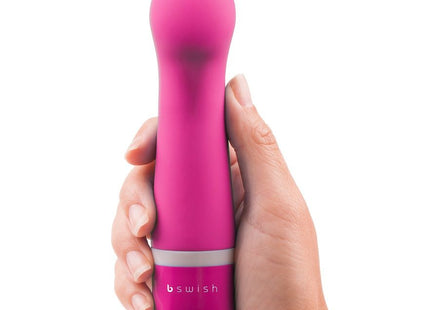 Ein lebhaft pinkes, ergonomisch gestaltetes persönliches vergnügungsgerät bswish bdesired deluxe curve rosa mit glattem, rundem kopf