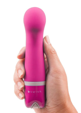 Ein lebhaft pinkes, ergonomisch gestaltetes persönliches vergnügungsgerät bswish bdesired deluxe curve rosa mit glattem, rundem kopf