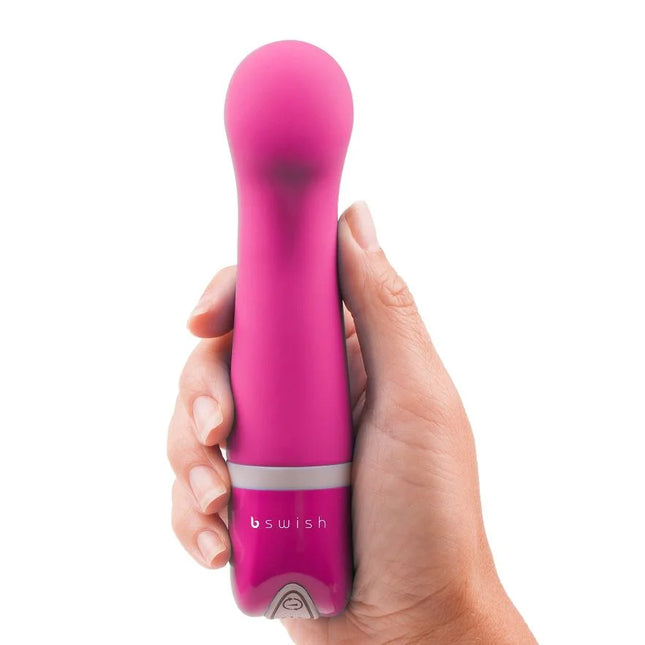 Ein lebhaft pinkes, ergonomisch gestaltetes persönliches vergnügungsgerät bswish bdesired deluxe curve rosa mit glattem, rundem kopf