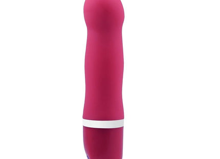 Ein schlanker, lebhafter pinkfarbener silikonvibrator b swish bdesired deluxe curve rosa mit weißem ring nahe der basis