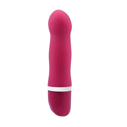 Ein schlanker, lebhafter pinkfarbener silikonvibrator b swish bdesired deluxe curve rosa mit weißem ring nahe der basis