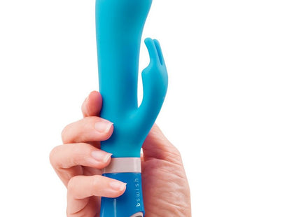 Ein glatter, ergonomischer blauer silikon vibrator in hasenform mit bedienfeld am fuß, b swish - bwild deluxe bunny rabbit vibrator jade