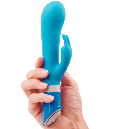 Ein glatter, ergonomischer blauer silikon vibrator in hasenform mit bedienfeld am fuß, b swish - bwild deluxe bunny rabbit vibrator jade