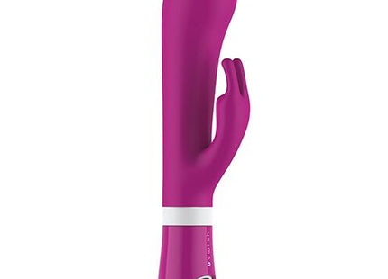 Ein schlanker, lebhafter magentafarbener b swish bwild deluxe bunny rabbit vibrator aus silikon mit weißem steuerband nahe dem stiel