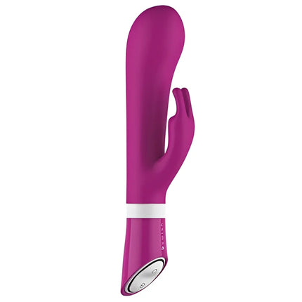 Ein schlanker, lebhafter magentafarbener b swish bwild deluxe bunny rabbit vibrator aus silikon mit weißem steuerband nahe dem stiel