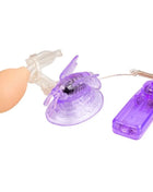 Lila klitorisstimulation vibrierender schmetterling adult toy aus durchsichtigem lila plastik mit beigeem ballon und fernbedienung