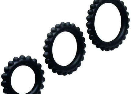 Set aus drei schwarzen silikon cockrings mit strukturierter zahnradkante in größen 2.8 2.4 und 1.9 cm von baile