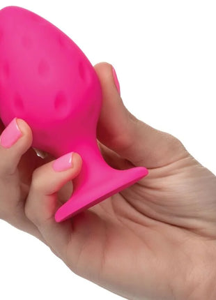 Ein lebhaftes pinkes silikon-butplug von calexotics mit strukturierter punktoberfläche und verbreitertem sockel