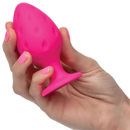 Ein lebhaftes pinkes silikon-butplug von calexotics mit strukturierter punktoberfläche und verbreitertem sockel