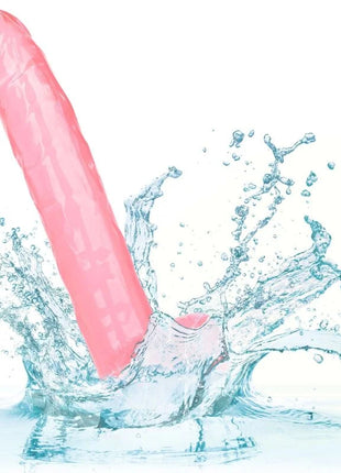 Rosafarbener silikon-dildo größe königin 25,5 cm mit strukturierter oberfläche und abgerundetem spitzenteil teils im spritzwasser