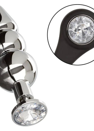 Shiny chrome-plated anal plug with three spherical beads and black silicone base featuring a clear crystal by CalExotics