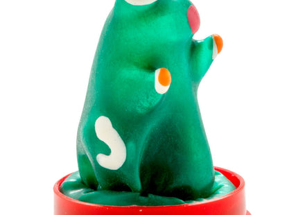 Grüne plastikfigur mit weißen und orangefarbenen akzenten auf rotem rundem sockel kondommodell frosch
