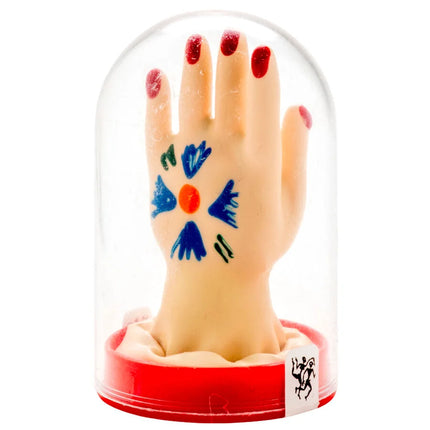Beige handmodell mit rotem nagellack und farbenfrohem design auf der handfläche in klarglasglocke