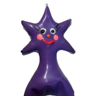 Lila sternförmige kerze mit fröhlichem gesicht schwarz augen rosa wangen rotes lächeln condomerie handbemalte neuheitskondome happy star xl
