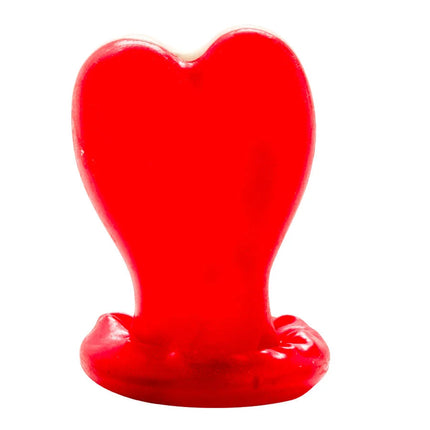 Ein glänzendes, rotes herzförmiges kerzenmodell mit leicht geschmolzenem boden von condomerie handbemalt