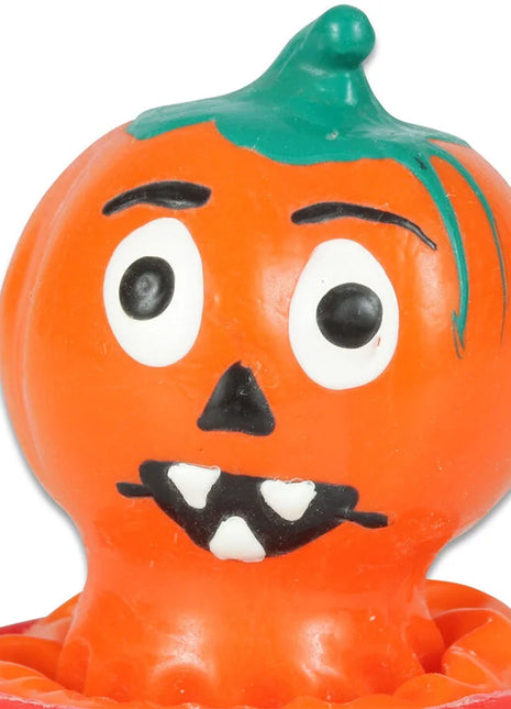 Orange plastik halloween kürbisfigur mit grünem stiel und schwarz-weißen handbemalten gesichtszügen, condomerie novelty kondome