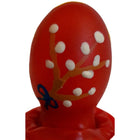 Ein lebhaft rotes, glänzendes osterei-kondom von condomerie mit handbemalten orangen zweigen und weißen blüten
