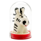 Eine charmante weiße zebrafigur mit schwarzen streifen und roten lippen unter einer glaskuppel auf rotem sockel