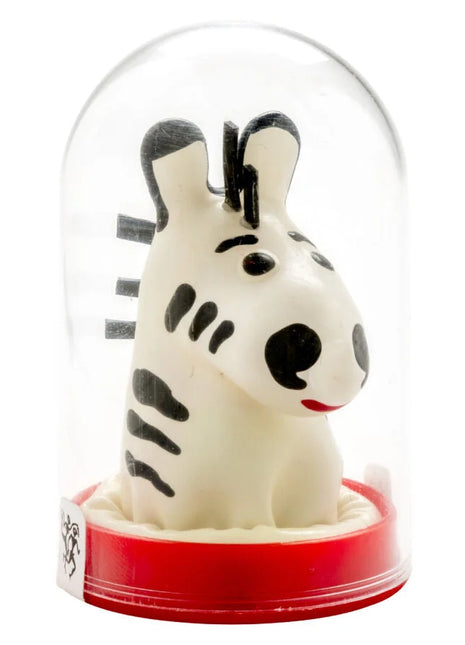 Eine charmante weiße zebrafigur mit schwarzen streifen und roten lippen unter einer glaskuppel auf rotem sockel