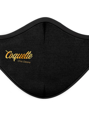 Schwarze wiederverwendbare stoffmaske mit gold stickerei coquette chic desire text