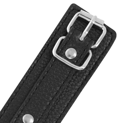 Handschellen aus schwarzem strukturiertem leder mit silbernen metallnieten und schnalle in dunkeloptik
