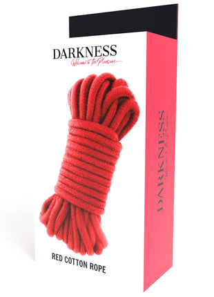 Rotes japanisches baumwollseil 10 m, ordentlich aufgerollt und verpackt in einer box mit label darkness und slogan willkommen zum vergnügen