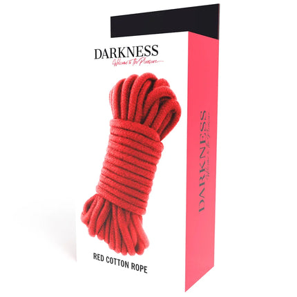 Rotes japanisches baumwollseil 10 m, ordentlich aufgerollt und verpackt in einer box mit label darkness und slogan willkommen zum vergnügen