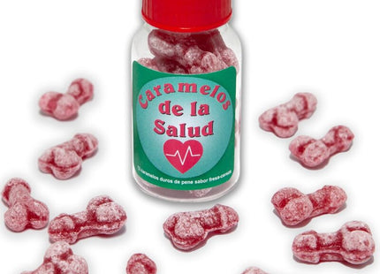 Eine klare glasflasche mit rotem deckel und grünem etikett enthält rosa, knochenförmige gesundheitsbonbons diablo picante eisbeere/kirsche