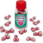 Eine klare glasflasche mit rotem deckel und grünem etikett enthält rosa, knochenförmige gesundheitsbonbons diablo picante eisbeere/kirsche
