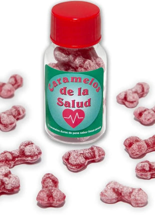 Eine klare glasflasche mit rotem deckel und grünem etikett enthält rosa, knochenförmige gesundheitsbonbons diablo picante eisbeere/kirsche