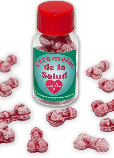 Eine klare glasflasche mit rotem deckel und grünem etikett enthält rosa, knochenförmige gesundheitsbonbons diablo picante eisbeere/kirsche