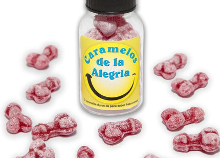 Eine klare glasflasche mit schwarzem deckel und gelbem etikett gefüllt mit rosa, penisförmigen joy-bonbons diablo picante erdbeere kirsche