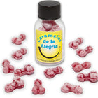 Eine klare glasflasche mit schwarzem deckel und gelbem etikett gefüllt mit rosa, penisförmigen joy-bonbons diablo picante erdbeere kirsche