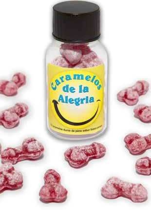 Eine klare glasflasche mit schwarzem deckel und gelbem etikett gefüllt mit rosa, penisförmigen joy-bonbons diablo picante erdbeere kirsche