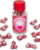 Ein klarer glasflasche mit rotem verschluss und pinkem etikett enthält rosa, knochenförmige karamellen zuckerstaubiert diablo picante liebensbonbons erdbeere kirsche