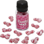 Eine klare plastflasche mit schwarzem deckel und pinkem etikett mit knochenmustern gefüllt mit roten zuckerbedeckten gummibärchen in form von penis mit erdbeer-kirsch-geschmack diablo picante candy sexy glas