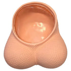 Peachfarbener silikon novelty planter in form eines pausbäckigen eierleerbeutels mit strukturierter oberfläche