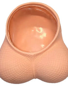 Peachfarbener silikon novelty planter in form eines pausbäckigen eierleerbeutels mit strukturierter oberfläche