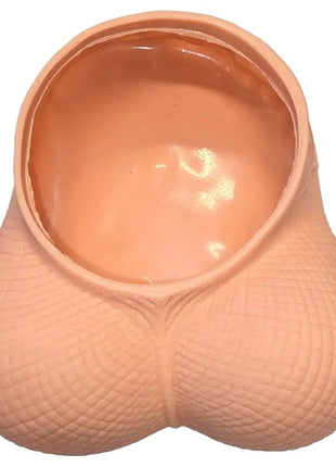 Peachfarbener silikon novelty planter in form eines pausbäckigen eierleerbeutels mit strukturierter oberfläche