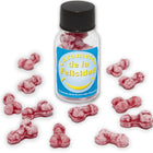 Ein klares glas mit schwarzem deckel enthält rosa bonbons in knochenform und trägt das etikett caramelos de la felicidad