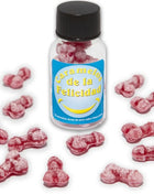 Ein klares glas mit schwarzem deckel enthält rosa bonbons in knochenform und trägt das etikett caramelos de la felicidad