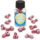 Ein klares glas mit schwarzem deckel enthält rosa bonbons in knochenform und trägt das etikett caramelos de la felicidad