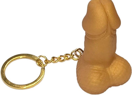 Tanfarbener silikon-schlüsselanhänger in penisform mit goldfarbenem metallring und kette diablo picante