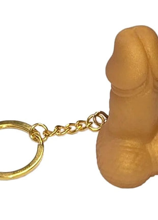 Tanfarbener silikon-schlüsselanhänger in penisform mit goldfarbenem metallring und kette diablo picante