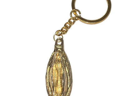 Goldfarbener metall-schlüsselanhänger diabolo picante mit detailliertem, länglichem bohnenförmigem anhänger und goldenem lippenmotiv