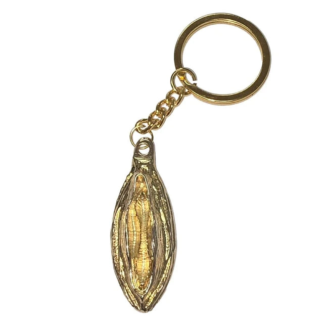 Goldfarbener metall-schlüsselanhänger diabolo picante mit detailliertem, länglichem bohnenförmigem anhänger und goldenem lippenmotiv