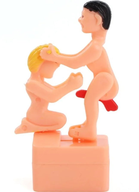 Pinkfarbene plast figurine diablo picante mit zwei spielerischen nackten figuren schwarz und blond haare